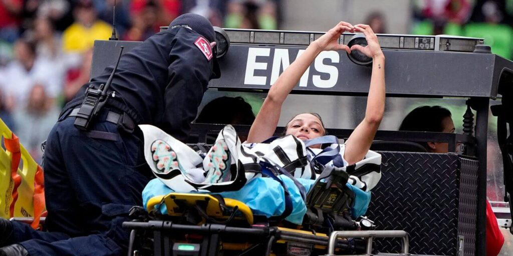 Mallory Swanson is taken off the field after injury.  Photo by Eric Gay/Associated Press